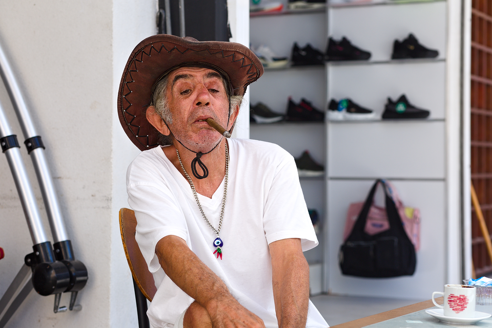 Famagusta, an urban cyclist rests in the shadow of the Retrò Café